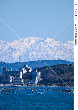 The Northern Alps, their snow-capped peaks shining brightly across Nanao Bay The Northern Alps, their snow-capped peaks shining brightly across Nanao Bay 141223181