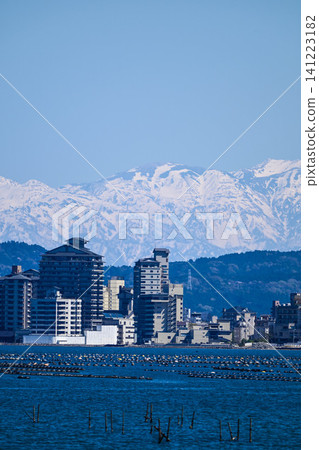 The Northern Alps, their snow-capped peaks shining brightly across Nanao Bay The Northern Alps, their snow-capped peaks shining brightly across Nanao Bay 141223182