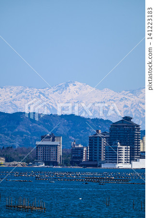 The Northern Alps, their snow-capped peaks shining brightly across Nanao Bay The Northern Alps, their snow-capped peaks shining brightly across Nanao Bay 141223183