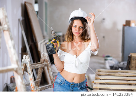 Portrait of attractive woman with drill Portrait of attractive woman with drill 141223394
