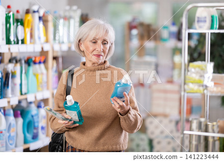 Mature woman choosing tooth care products in department store 141223444