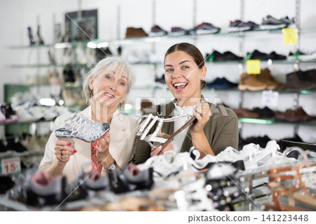 Young woman with elderly mother is choosing sandals Young woman with elderly mother is choosing sandals 141223448