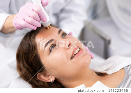 Young woman having face radiolifting procedure 141223486