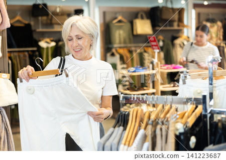 She peruses store for perfect pair of trousers She peruses store for perfect pair of trousers 141223687