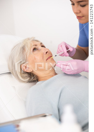 Old woman having mesotherapy procedure on her face Old woman having mesotherapy procedure on her face 141223743