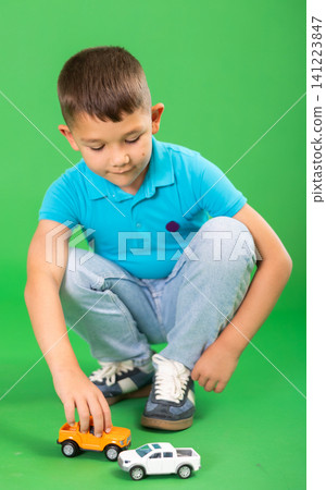 Boy in jeans with toy cars 141223847