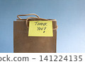 Handwritten Thank you note on a brown gift bag. 141224135
