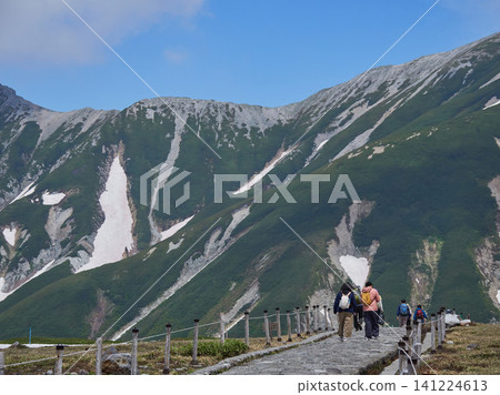 A view of tourists at the summit of Murodo Mountain on the Tateyama Kurobe Alpine Route, a popular summer tourist spot, and the scenery of the Tateyama mountain range. A view of tourists at the summit of Murodo Mountain on the Tateyama Kurobe Alpine Route, a popular summer tourist spot, and the scenery of the Tateyama mountain range. 141224613