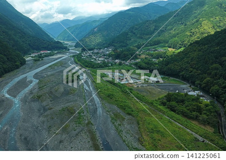 An aerial photograph showing a mountain village along the Abe River in Shizuoka Prefecture and the river itself. An aerial photograph showing a mountain village along the Abe River in Shizuoka Prefecture and the river itself. 141225061