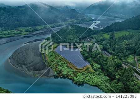 Aerial photograph of a group of solar panels installed in a foggy mountainous area along the Oi River in Shizuoka Prefecture. Aerial photograph of a group of solar panels installed in a foggy mountainous area along the Oi River in Shizuoka Prefecture. 141225093