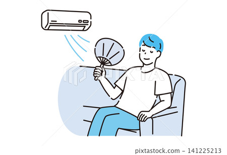 A man cooling off with an air conditioner and a fan. A man cooling off with an air conditioner and a fan. 141225213