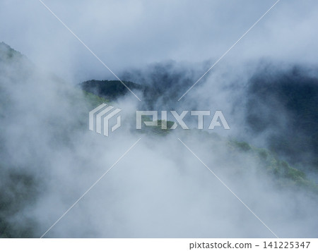 A mountain landscape in the tourist area of Okuhida on a rainy summer day. A mountain landscape in the tourist area of Okuhida on a rainy summer day. 141225347