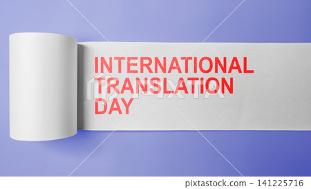 Minimalist conceptual banner for International Translation Day, featuring red text revealed on an unrolled white paper roll over a purple background 141225716