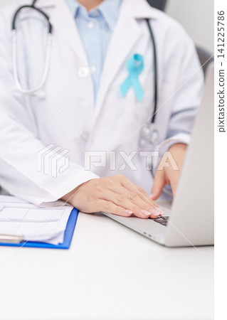 doctor using laptop and report notes on notebook. blue Ribbon concept of November Prostate Cancer Awareness month, Diabetes day , Men Health, International men, Father day. world cancer day doctor using laptop and report notes on notebook. blue Ribbon concept of November Prostate Cancer Awareness month, Diabetes day , Men Health, International men, Father day. world cancer day 141225786