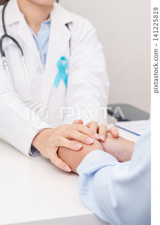 doctor holding patient hand to comfort and support with empathy. blue Ribbon concept of November Prostate Cancer Awareness month, Diabetes day , Men Health, International men, Father day doctor holding patient hand to comfort and support with empathy. blue Ribbon concept of November Prostate Cancer Awareness month, Diabetes day , Men Health, International men, Father day 141225819