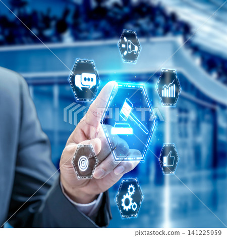 A businessman interacts with a futuristic digital interface featuring a central gavel icon surrounded by business, marketing, and compliance symbols in a modern office A businessman interacts with a futuristic digital interface featuring a central gavel icon surrounded by business, marketing, and compliance symbols in a modern office 141225959