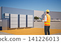 Asian engineer or technician with group of battery energy storage systems 141226013