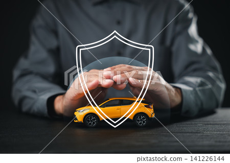 Car insurance serves to protect safe transport, offering safety and trust with secure protection and financial assurance for yellow toy car under protective hands and shield outline 141226144