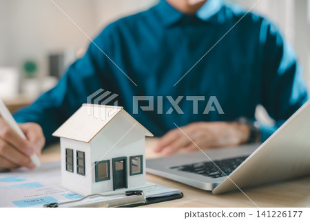 Signing real estate contract property mortgage finance approved home buying document for homeowner house tenant investment insurance, professional using laptop at office workspace 141226177