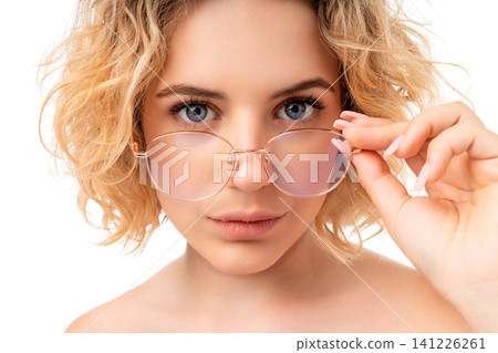 Woman adjusts her glasses while looking forward, isolated, PNG Woman adjusts her glasses while looking forward, isolated, PNG 141226261