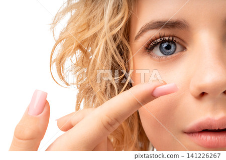 Girl applies eye care product with focus on her hand, isolated, PNG Girl applies eye care product with focus on her hand, isolated, PNG 141226267
