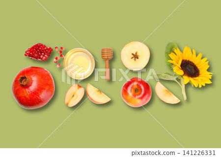 Creative fruit display with honey on a green backdrop Creative fruit display with honey on a green backdrop 141226331