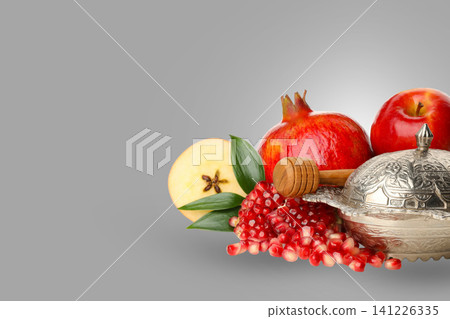 Pomegranates apples and honey are arranged on a neutral background Pomegranates apples and honey are arranged on a neutral background 141226335