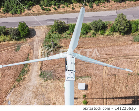 Worker performing routine inspection inside wind turbine nacelle. Top view Worker performing routine inspection inside wind turbine nacelle. Top view 141226630