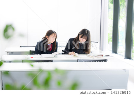 Japanese middle and high school girls studying together in the classroom, teaching each other: School life and exam/test preparation through cooperation. Japanese middle and high school girls studying together in the classroom, teaching each other: School life and exam/test preparation through cooperation. 141226915
