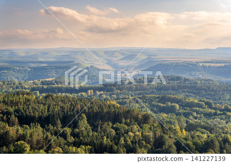 Layers of green mountains and hills in the haze during sunset. Panoramic View of Green hills and Meadow. Layers of green mountains and hills in the haze during sunset. Panoramic View of Green hills and Meadow. 141227139