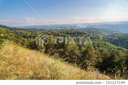 Layers of green mountains and hills in the haze during sunset. Panoramic View of Green hills and Meadow. Layers of green mountains and hills in the haze during sunset. Panoramic View of Green hills and Meadow. 141227144