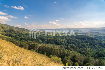 Layers of green mountains and hills in the haze during sunset. Panoramic View of Green hills and Meadow. Layers of green mountains and hills in the haze during sunset. Panoramic View of Green hills and Meadow. 141227150