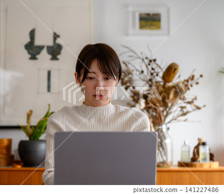 Woman working on a laptop Woman working on a laptop 141227486