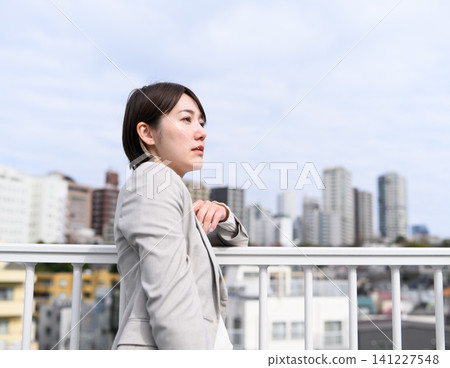 Businesswoman looking far away Businesswoman looking far away 141227548