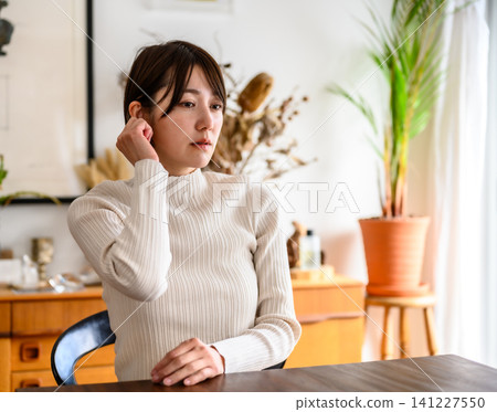 Woman thinking in the room Woman thinking in the room 141227550