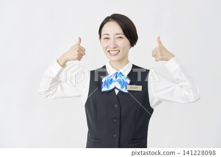 Female staff member (receptionist/bank employee) making a thumbs-up sign with both hands against a white background. 141228098