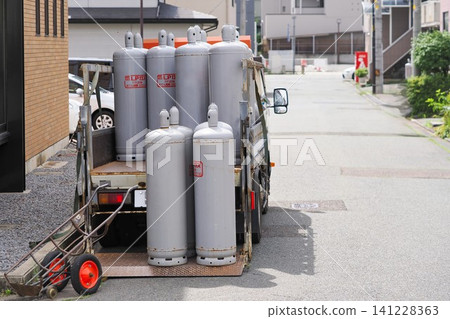 LP gas delivery truck working in a residential area LP gas delivery truck working in a residential area 141228363