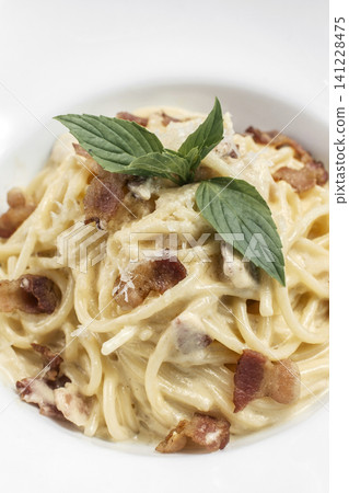 spaghetti carbonara creamy pasta with bacon and chesse on restaurant table spaghetti carbonara creamy pasta with bacon and chesse on restaurant table 141228475