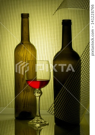 Still life with glass bottles and a glass of red wine Still life with glass bottles and a glass of red wine 141228766