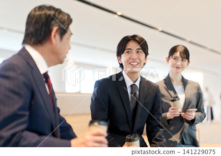Asian business people chatting in the office. Asian business people chatting in the office. 141229075
