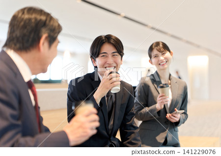 Asian business people chatting in the office. Asian business people chatting in the office. 141229076