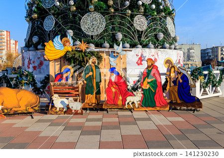 Wooden Christmas Nativity scene with Holy family in city park 141230230