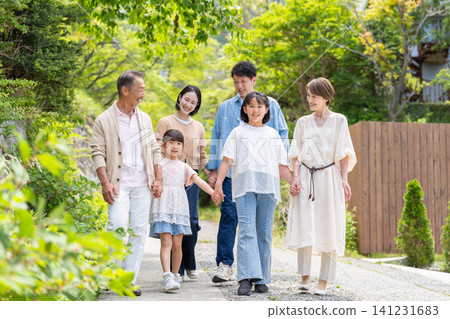 An image of a family taking a walk together across three generations. An image of a family taking a walk together across three generations. 141231683