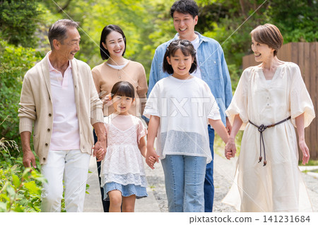 An image of a family taking a walk together across three generations. An image of a family taking a walk together across three generations. 141231684