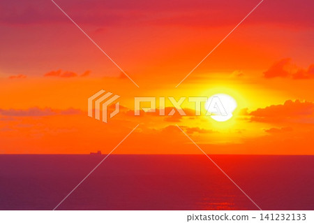 Fiery sunset over sea with cargo ship silhouette and copy space Fiery sunset over sea with cargo ship silhouette and copy space 141232133