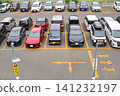 Passenger cars lined up in a crowded parking lot 141232197