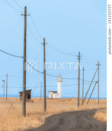 A road in spring where you can see the Notsuke Cape Lighthouse on the Notsuke Peninsula in Betsukai Town, Hokkaido. A road in spring where you can see the Notsuke Cape Lighthouse on the Notsuke Peninsula in Betsukai Town, Hokkaido. 141232557
