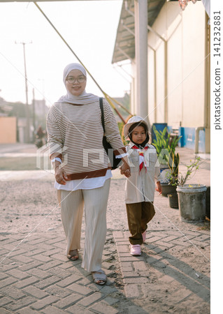 Mother and Child Walking Together Holding Hands Mother and Child Walking Together Holding Hands 141232881