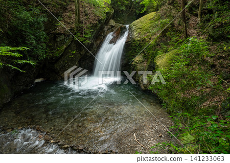 A pure waterfall cascading down a rocky face. A pure waterfall cascading down a rocky face. 141233063