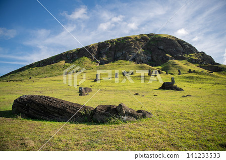 Majestic moai statue on peaceful green grass mountain in easter island chile Majestic moai statue on peaceful green grass mountain in easter island chile 141233533